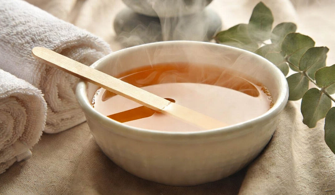 image of a bowl of wax with applicator