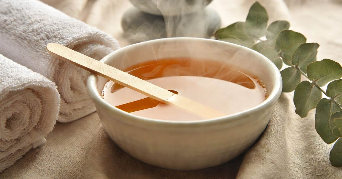 image of a bowl of wax with applicator